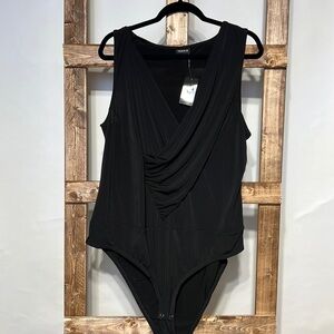 Torrid black swoosh V-neck sleeveless bodysuit. Size 3X. NWT.